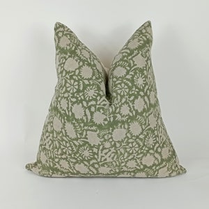 May include: A green and white floral patterned pillow cover. The pillow cover is made of a soft, linen fabric.