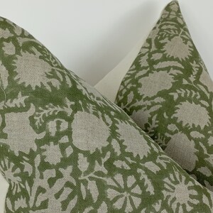 May include: Two green and white patterned pillow covers with a floral design. The pillow covers are made of a linen fabric.
