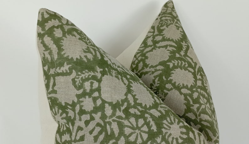 May include: Two green and white patterned pillow covers with a floral design. The pillow covers are made of a linen fabric.