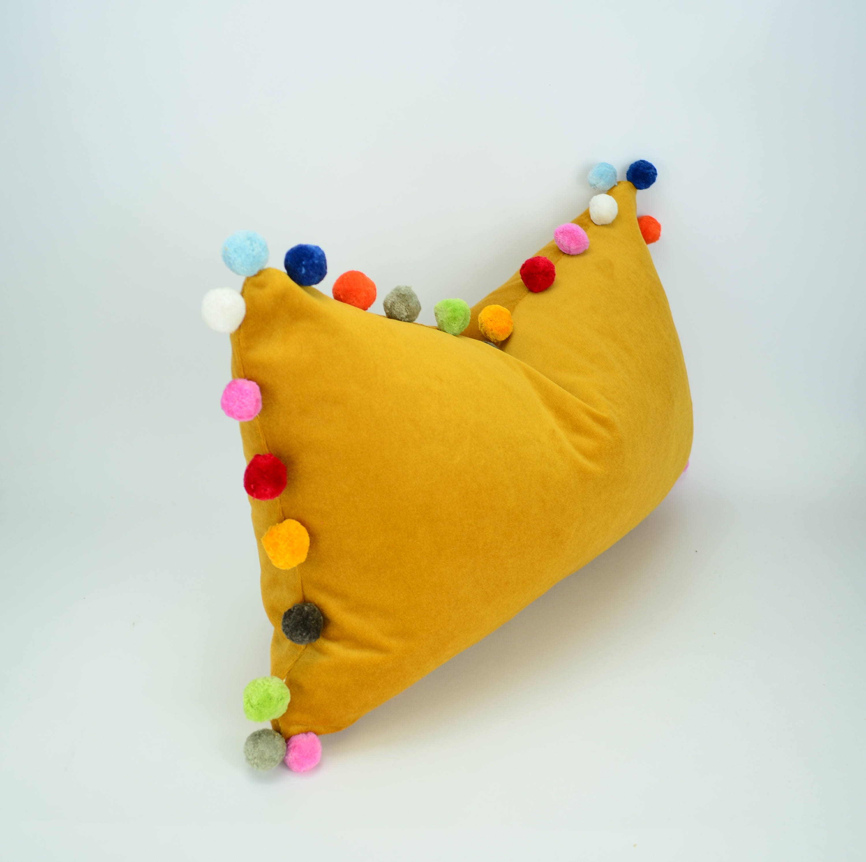 yellow pom pom pillow
