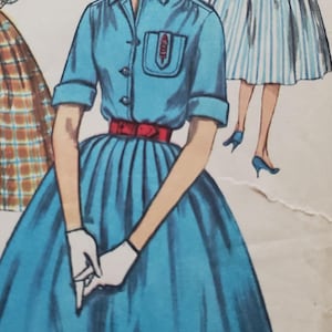 May include: Illustration of a woman in a blue dress with a red belt, white gloves, and a collared shirt. The dress has a full skirt. Another woman is in the background wearing a striped dress. The image is a vintage fashion illustration.