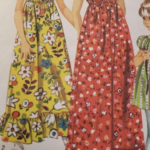 Puede incluir: Patrón de costura Simplicity vintage con ilustraciones de tres niñas con vestidos largos florales. Los vestidos tienen dobladillos con volantes y son en amarillo, rojo y verde. El patrón es para la talla 8 con un contorno de pecho de 68,6 cm.