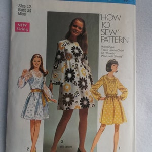 May include: Vintage Simplicity sewing pattern envelope. The cover features illustrations of three dresses, including a mini-length floral dress. Text includes "How to Sew Pattern" and sizing information for Misses and Junior Petites.