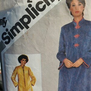 May include: A vintage Simplicity sewing pattern with two different designs. The first design is a yellow coat with a zipper closure. The second design is a blue robe with a mandarin collar and red buttons. The pattern number is 9782 and the price is $2.00.