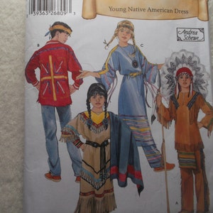 May include: A Simplicity Historic sewing pattern envelope, number 6448, for a Young Native American Dress. The package features illustrations of four children wearing various historical-style garments, including fringed tunics, trousers, and a headdress.