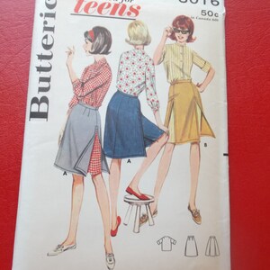 May include: Vintage Butterick sewing pattern envelope featuring illustrations of three teen girls in skirts and tops. The envelope is white with red text, including "proportioned for teens" and size information. The bust size is 33 inches.