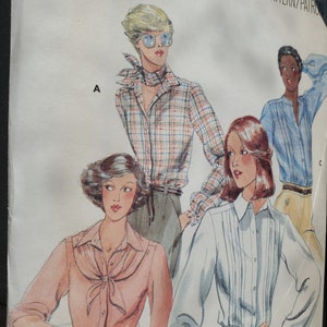 May include: A vintage sewing pattern featuring illustrations of women's blouses. The blouses have various styles, including a plaid button-down, a light pink blouse with a tie, and a white pleated blouse. The pattern is labeled "Fabric Warehouse #157".
