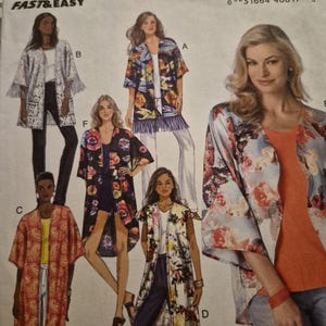 May include: A Butterick B6176 sewing pattern envelope featuring illustrations of various open-front kimono-style jackets. The designs include options with fringe trim, floral prints, and paisley patterns, displayed on figures wearing casual tops and pants.