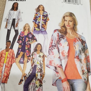 May include: A Butterick sewing pattern, B6176, featuring illustrations of various kimono-style jackets with floral and patterned designs. The pattern includes fringe details and different sleeve lengths. The size range is Lrg-Xlg-XXl.