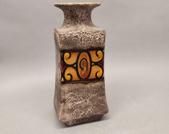 May include: A square ceramic vase with a textured brown glaze and a band of colorful geometric designs around the middle.