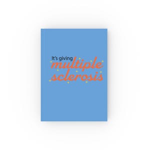 May include: A light blue notebook featuring the text "It's giving multiple sclerosis" in orange and yellow. The notebook is rectangular and has a minimalist design, with the text centered on the cover.