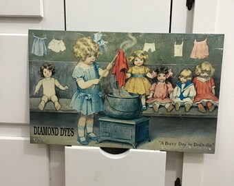 Bessie Pease Gutmann Metal Tin Sign "A busy day in DOLLVILLE" Diamond Dyes