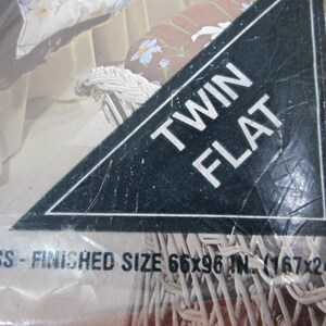 May include: Twin size flat mattress packaging with a floral design. The mattress is made of a blend of 65% polyester. The packaging states the finished size is 66x96 inches (167x243 centimeters).