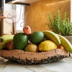 May include: A rustic, cork bowl filled with fresh produce, including avocados, bananas, apples, a lemon, and a carrot. A small potted herb garden is visible in the background, adding a touch of greenery to the kitchen setting.