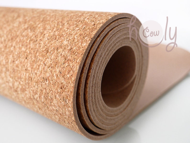 May include: A roll of cork sheet, rolled up and showing the brown cork texture. The cork is a natural material and is often used for crafts and DIY projects.