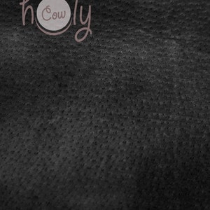 May include: Dark gray textured background with the words "holy cow" in a cursive font. The word "Cow" is inside a light gray circle.