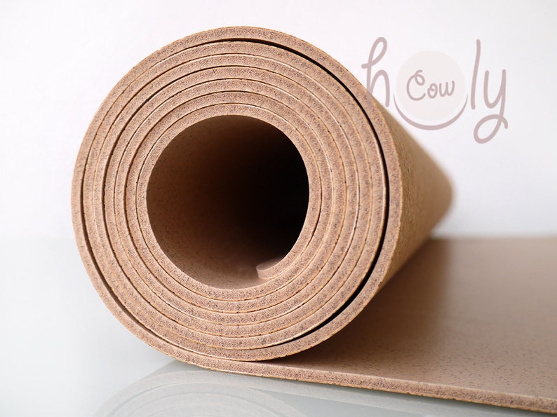 May include: A rolled up sheet of cork material in a light brown color. The cork is rolled tightly and the edges are visible.