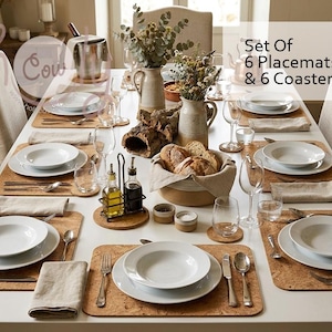 May include: A set of 6 placemats and 6 coasters made of natural cork, arranged on a dining table with white ceramic bowls, plates, silverware, glassware, and a centerpiece of dried flowers in ceramic pitchers and a basket of bread.