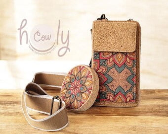 May include: A cork crossbody bag, round coin purse, and matching strap. The bag and purse feature a colorful mandala design in red, orange, and teal. The strap is a tan color with a white trim. The brand name "holy cow chic" is visible.