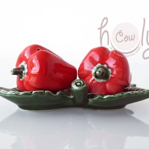 Handcrafted Ceramic Salt And Pepper Shaker Set In The Shape Of Red Peppers On A Green Ceramic Leaf