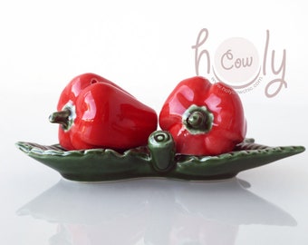 Handcrafted Ceramic Salt And Pepper Shaker Set In The Shape Of Red Peppers On A Green Ceramic Leaf