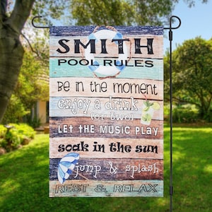 May include: A wooden sign with the text "SMITH POOL RULES" and a list of rules for enjoying a pool party. The rules include "Be in the moment", "enjoy a drink (or two)", "LET THE MUSIC PLAY", "soak in the sun", "jump & splash", and "REST & RELAX".