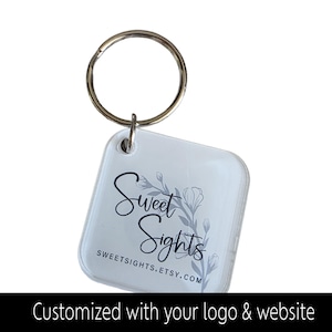 May include: A clear, square keychain with a silver key ring. The keychain displays the text "Sweet Sights" in black script with a floral design. The website address SWEETSIGHTS.ETSY.COM is also visible. The bottom of the image reads "Customized with your logo & website."