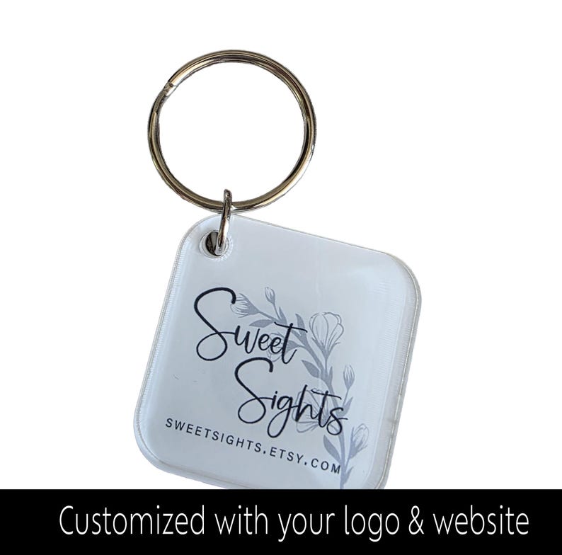 May include: A clear, square keychain with a silver key ring. The keychain displays the text "Sweet Sights" in black script with a floral design. The website address SWEETSIGHTS.ETSY.COM is also visible. The bottom of the image reads "Customized with your logo & website."