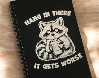 Hang in there, it gets worse raccoon journal for 2026