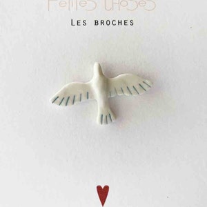 White and blue flying bird porcelain brooch