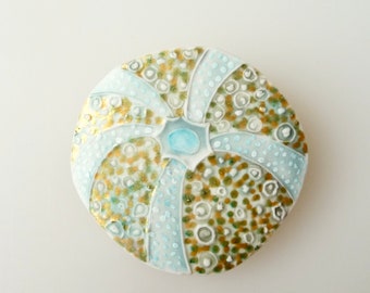 Porcelain sea urchin shell brooch