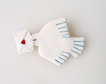 Porcelain brooch with bird and heart