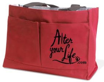 May include: Red canvas tote bag with two pockets on the front. The front pocket has the text "Alter your life.com" printed in black.