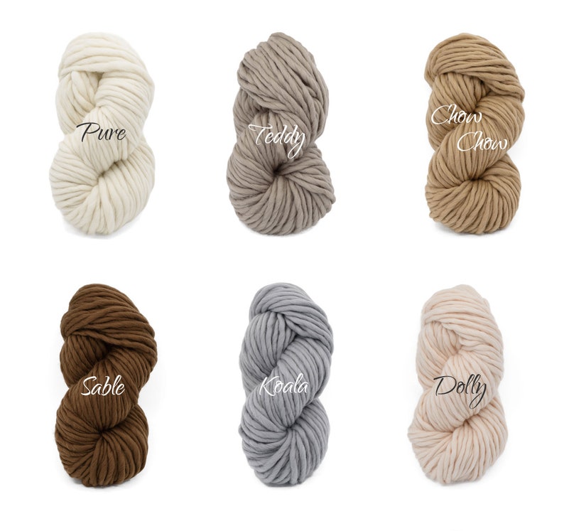 May include: Six skeins of chunky yarn in various colours, including white, beige, brown, grey, and pink. The yarn is labelled with the names "Pure", "Teddy", "Chow Chow", "Sable", "Koala", and "Dolly".