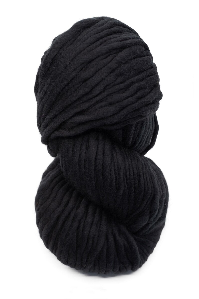 May include: A large ball of black yarn, ideal for knitting or crocheting chunky projects.
