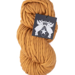 May include: A skein of chunky, mustard yellow yarn. The yarn is made of wool and is perfect for knitting or crocheting.