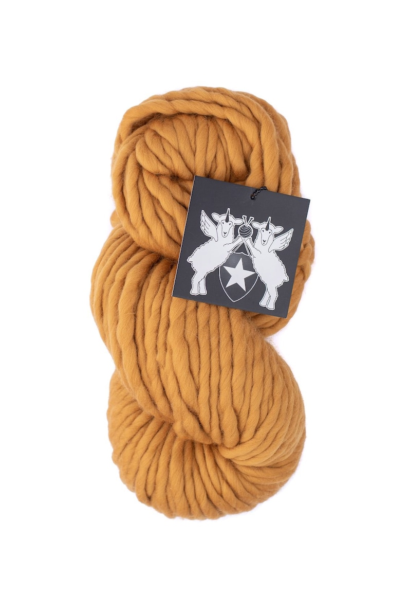 May include: A skein of chunky, mustard yellow yarn. The yarn is made of wool and is perfect for knitting or crocheting.