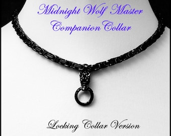 May include: Black metal collar with a wolf head pendant and a ring. The collar is labeled "Midnight Wolf Master Companion Collar Locking Collar Version".