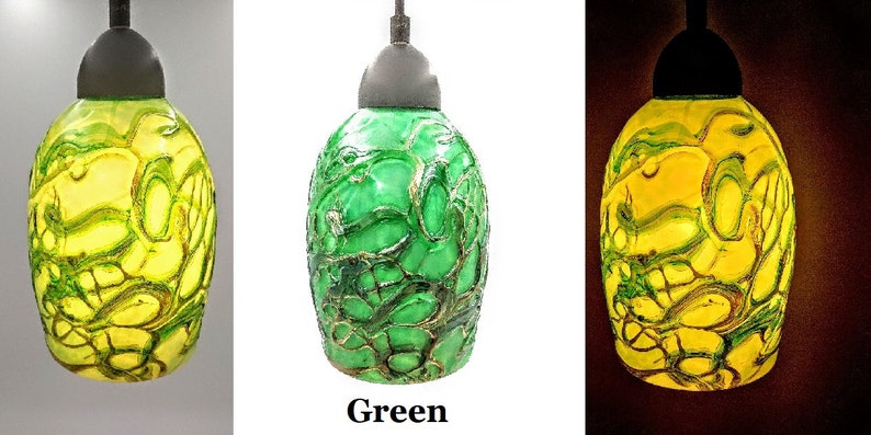 K&ouml;nnte beinhalten: Drei Glas-Pendelleuchten mit einem gr&uuml;nen und gelben Marmormuster. Die Leuchten werden in verschiedenen Lichtverh&auml;ltnissen gezeigt, wobei die mittlere Leuchte mit "Gr&uuml;n" beschriftet ist.