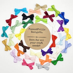May include: A collection of small, colorful satin bows in various shades, including red, blue, green, and yellow, arranged in a circular pattern. A brown circular label in the center reads "FunandFrills DesignCo." and "Here for all your craft needs!!"