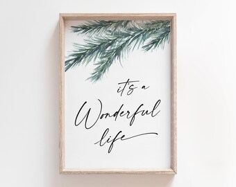 May include: A framed print with a watercolor illustration of pine branches and the text "it's a wonderful life".
