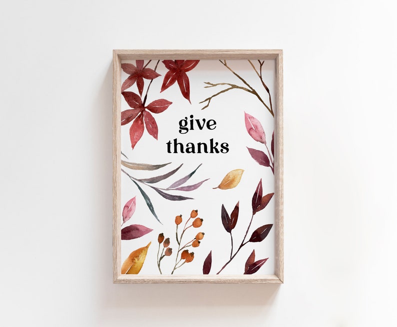 May include: A framed print featuring a watercolour design of autumn leaves and berries. The print includes the text "give thanks" in black.