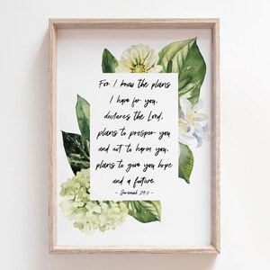 May include: A framed print featuring a watercolour floral design and a quote from Jeremiah 29:11, "For I know the plans I have for you, declares the Lord, plans to prosper you and not to harm you, plans to give you hope and a future."