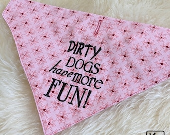 May include: Pink dog bandana with a red and white pattern and the text "Dirty dogs have more FUN!" embroidered in black.