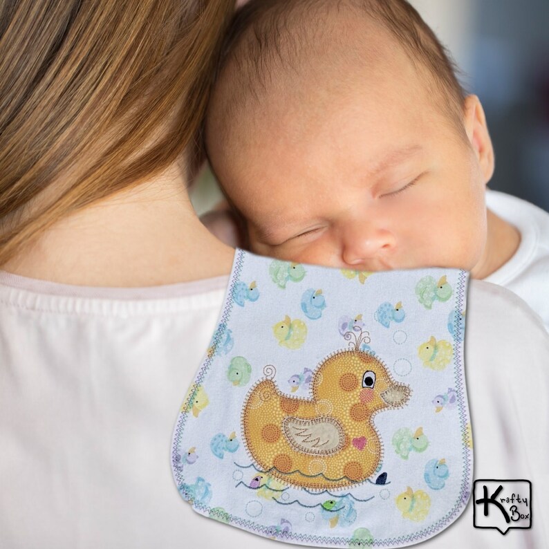 Baby burping cloth made with soft flannel rubber ducky design and accented with an embroidered rubber duck and detail stitching all through the edge.