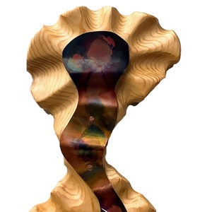May include: A wooden sculpture with a wavy, organic shape. The sculpture is painted in shades of brown, copper, and iridescent colors. The top of the sculpture is shaped like a flower.
