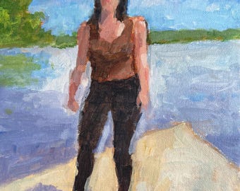 May include: An oil painting on canvas depicting a figure standing on a light-colored surface near a body of water. The figure wears a brown sleeveless top and dark pants. The background features a blue sky, a distant green shoreline, and water.