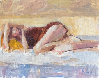 May include: An oil painting on canvas depicting a figure lying down in a reclined position. The figure wears a dark brown garment against a background of muted yellow, beige, and light blue tones. The brushwork is visible, and the name Ruby is signed.