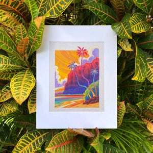 May include: A framed illustration of a tropical scene with palm trees and a red mountain in the background. The sky is a vibrant orange and yellow, and the water is a deep blue. The illustration is in a white frame with a white mat.