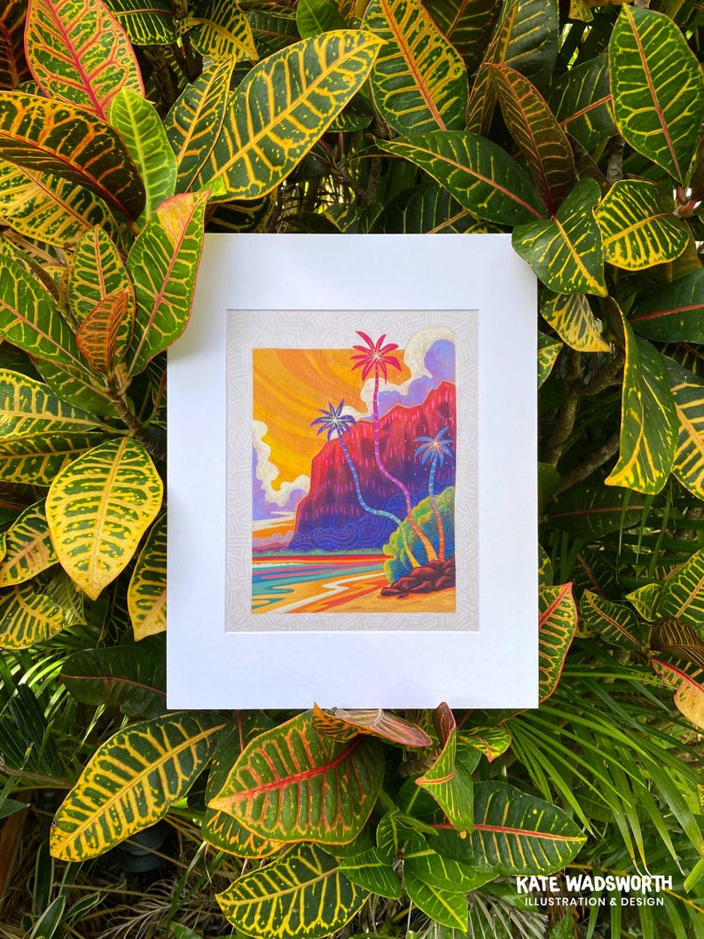 May include: A framed illustration of a tropical scene with palm trees and a red mountain in the background. The sky is a vibrant orange and yellow, and the water is a deep blue. The illustration is in a white frame with a white mat.